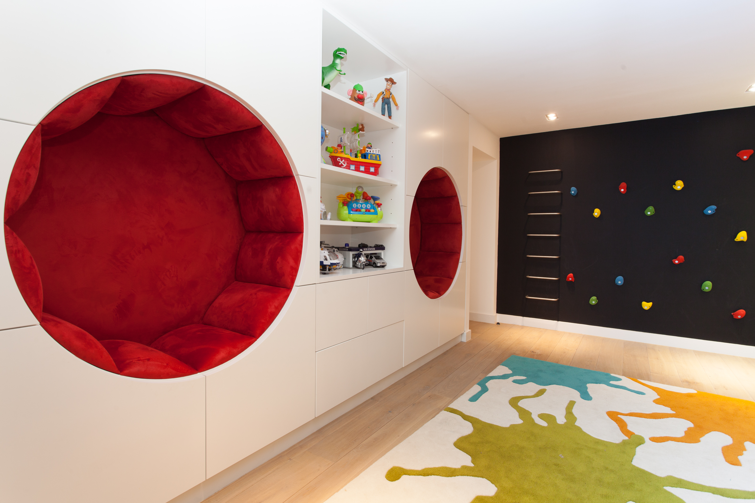 children's playroom with circular seating and chalkboard climbing wall